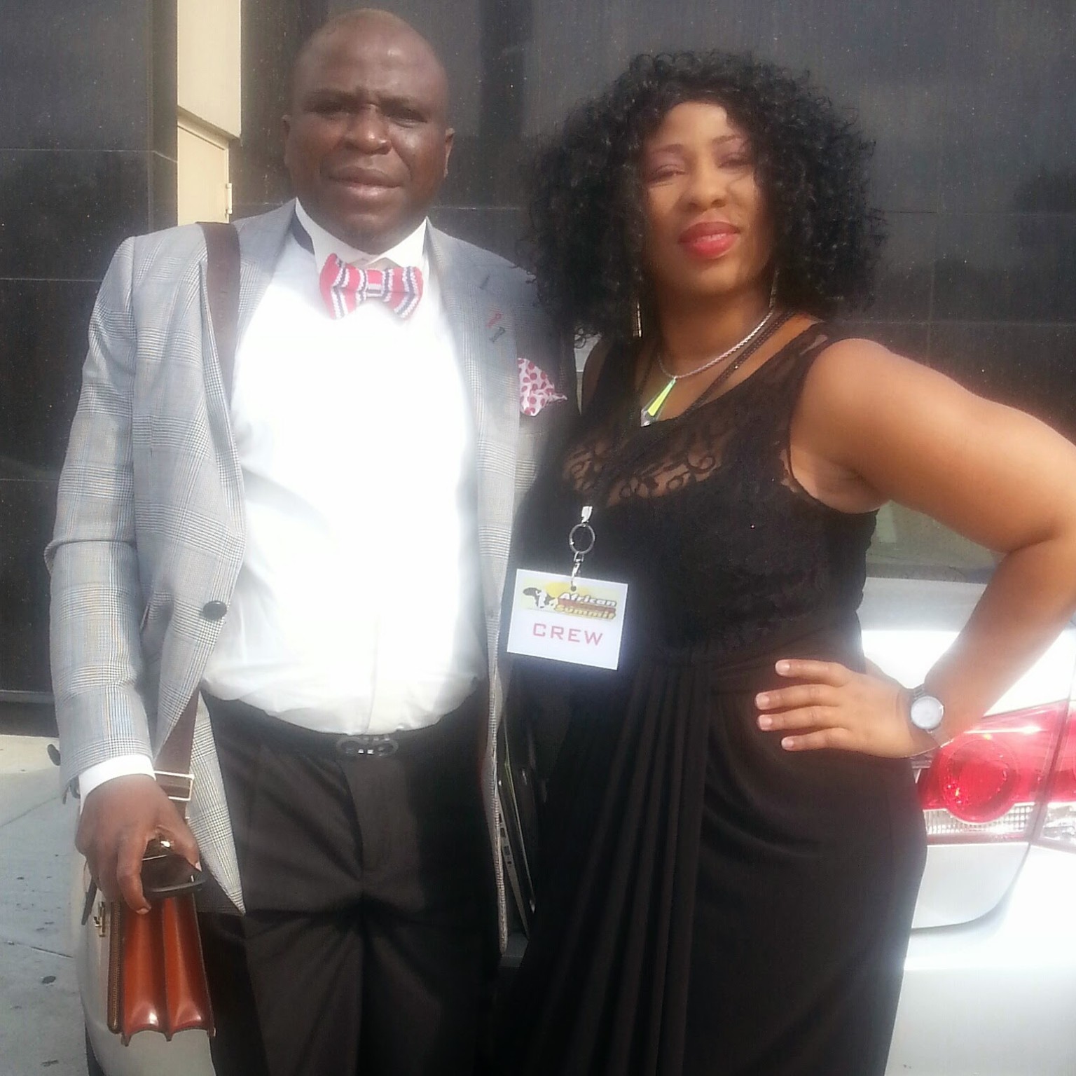 Event crew member wearing an African Women Summit credential with a guest in New York