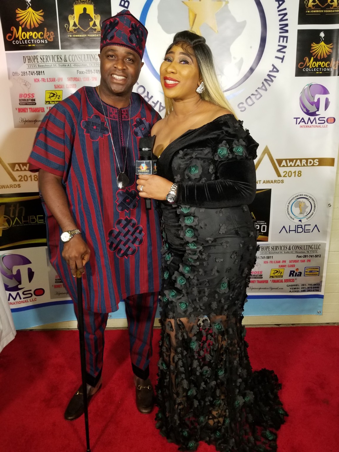Dr. Ranti holding a microphone with a Nigerian entertainment personality on the AHBEA Awards red carpet